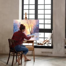 A wooden easel supporting a canvas in an artist’s studio