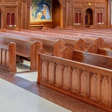 Rows of wooden pews inside a church
