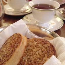 A cup of tea served with crumpets.