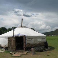 Traditional round yurts in a Mongolian landscape