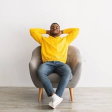 Person sitting peacefully in a restful setting