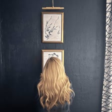 A picture frame hanging crooked on a wall