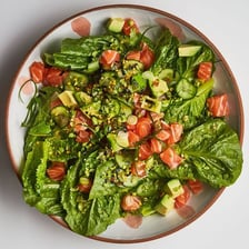 Green peas coated with wasabi seasoning in a bowl.