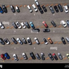 An outdoor parking lot filled with parked cars