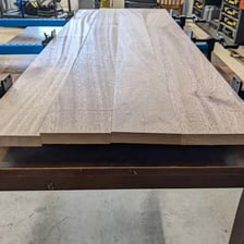 Wooden board visibly warped into a curved shape