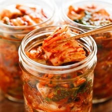 A bowl of red Korean kimchi made from fermented cabbage.