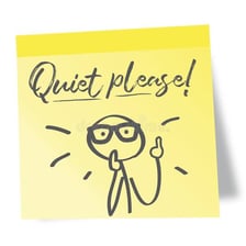 A person leaning in to quietly get someone’s attention.