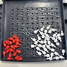 A Battleship game board with ships and marked hits
