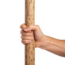 A hand gripping an object firmly