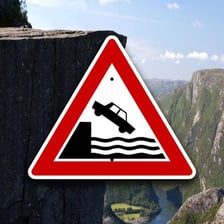A warning sign near a dangerous cliff edge