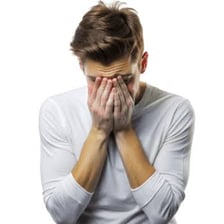 A person showing an expression of sadness or regret.