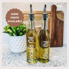 Bottles of olive oil and avocado oil shown together.