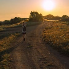 A person wandering along a rural path