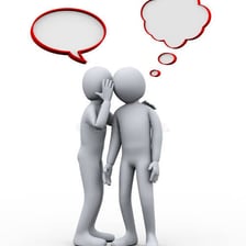 One person whispering information to another.