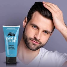 A container of hair gel beside styled hair.