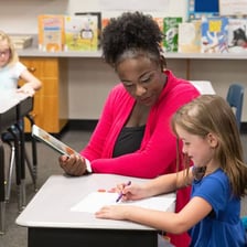 A teacher evaluating written student work.