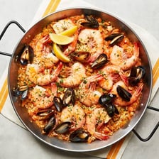 A pan of golden Spanish paella rice seasoned with saffron