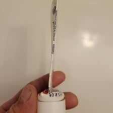 A person squeezing the last bit of toothpaste from a tube.