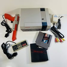 A Nintendo Entertainment System with the Duck Hunt game and light gun.