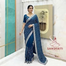 A person wearing a traditionally draped Indian sari