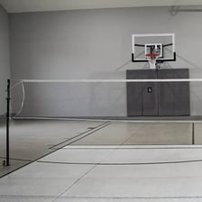 A badminton net dividing a court.