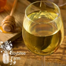 A glass of golden honey mead.