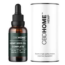 A bottle of CBD oil shown beside hemp leaves