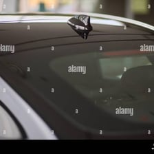 A close-up view of an antenna mounted on a car roof.