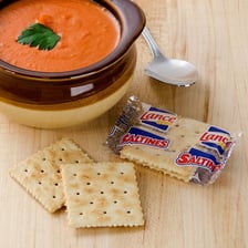 Saltine crackers arranged beside a bowl of soup