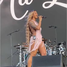 R&B singer Ari Lennox performing on stage.
