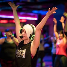 People dancing at a silent disco while wearing headphones