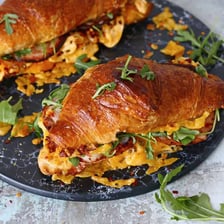 A breakfast sandwich served inside a croissant