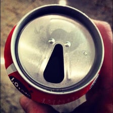 A close-up of the pull tab on a soda can