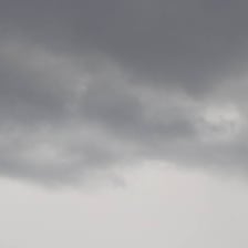 A uniformly gray sky filled with gloomy overcast clouds