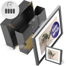 A small wall safe concealed behind a framed portrait
