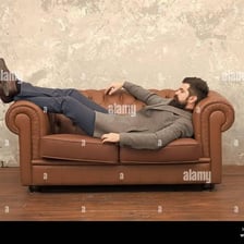 A person sleeping briefly on a sofa.
