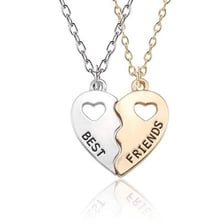 Two friends wearing matching necklaces.