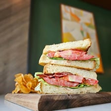 A BLT sandwich displayed at a deli counter.