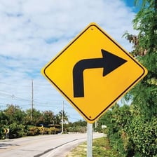 A yellow road sign warning of deer crossing