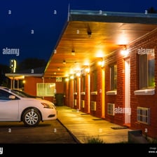 A roadside motel with illuminated rooms