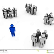 A person walking separately from a larger group
