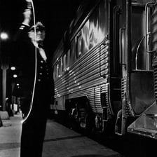 A train conductor beside a train preparing for departure