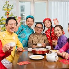 A family celebrates Vietnamese Lunar New Year with festive decorations.
