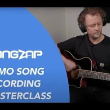 A musician recording an early song demo in a studio