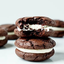Several Oreo chocolate sandwich cookies with white cream centers