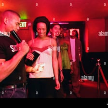 A nightclub bouncer checking a patron's identification card.
