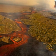 An erupting volcano forcefully ejecting lava and ash