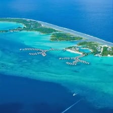 An aerial view of Bora Bora surrounded by a blue lagoon.