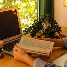 A person reading an online blog with an annoyed expression.