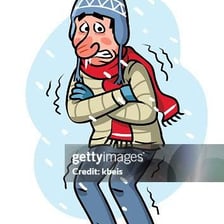 A bundled-up person shivering outdoors in cold weather.